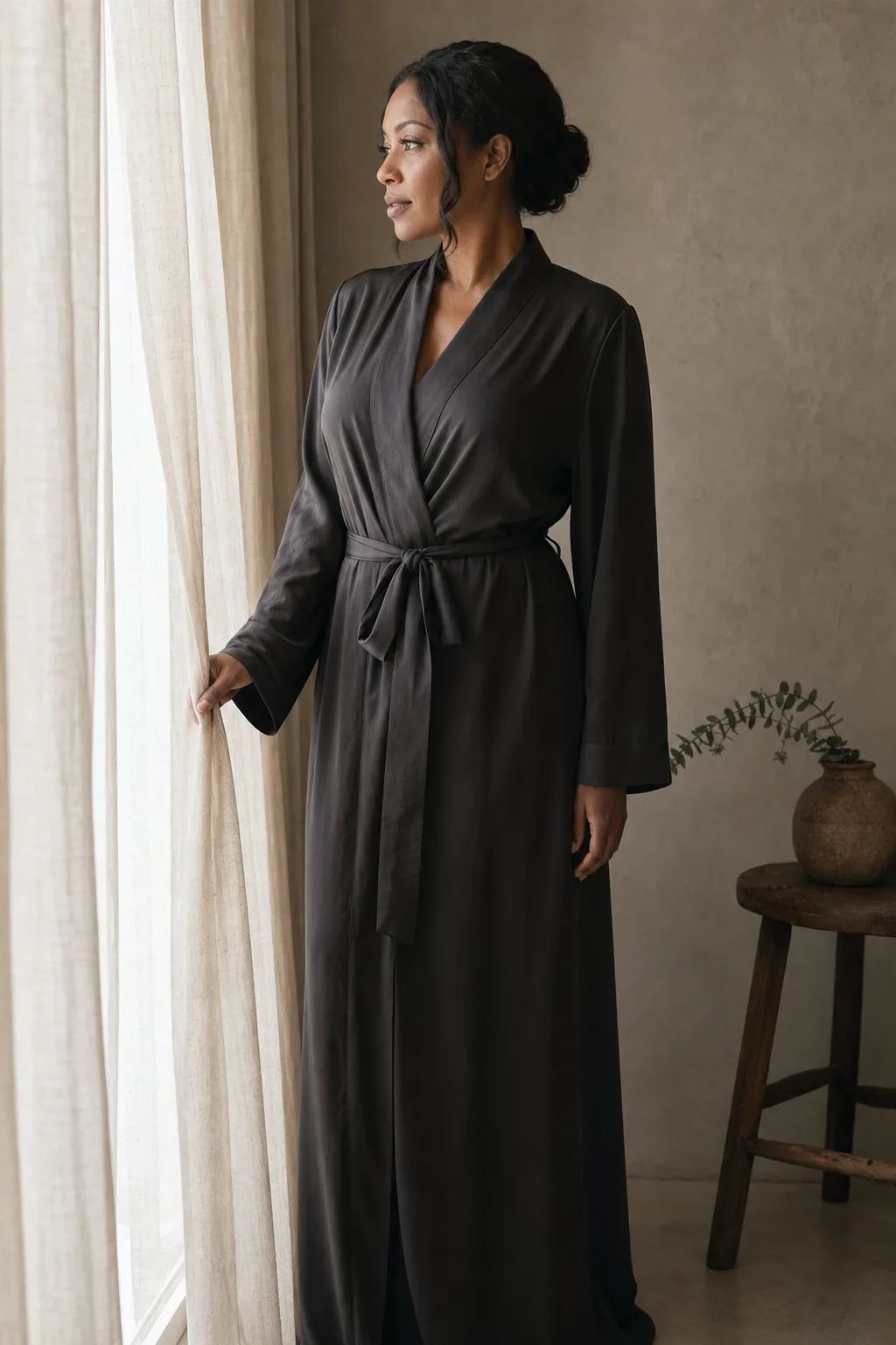 Intimate editorial portrait in a charcoal silk robe